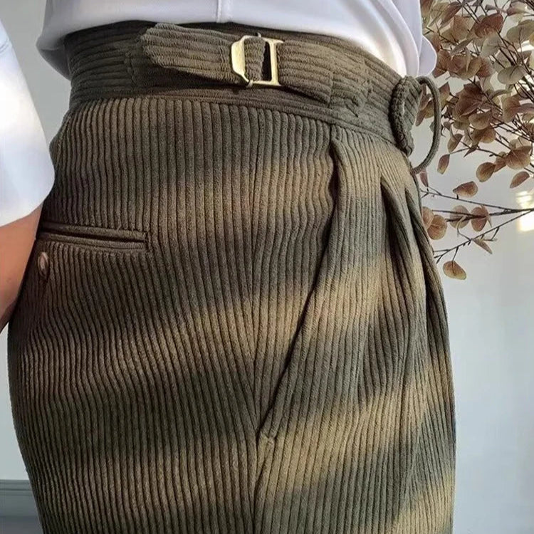 Zoom sur le pantalon LOXLEY vert en velours côtelé. La coupe slim s’ajuste parfaitement à la silhouette, tandis que la ceinture ajustable assure un confort optimal.