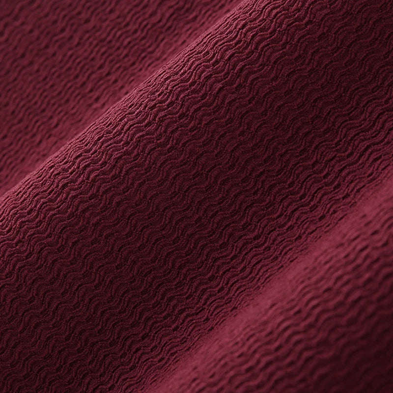 Gros plan sur le tissu en tricot bordeaux, texture fine et extensible