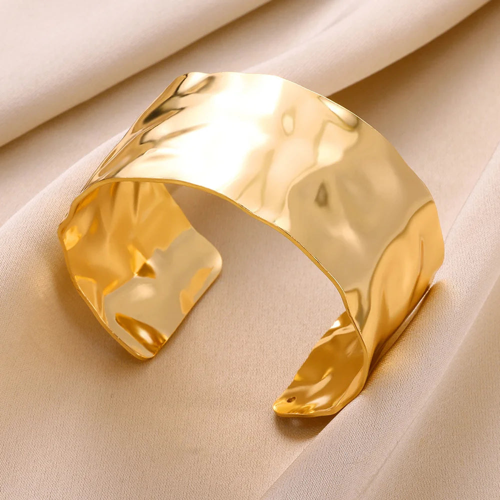 Bracelet manchette doré en acier inoxydable, bijou pour femme à la forme irrégulière et look vintage.